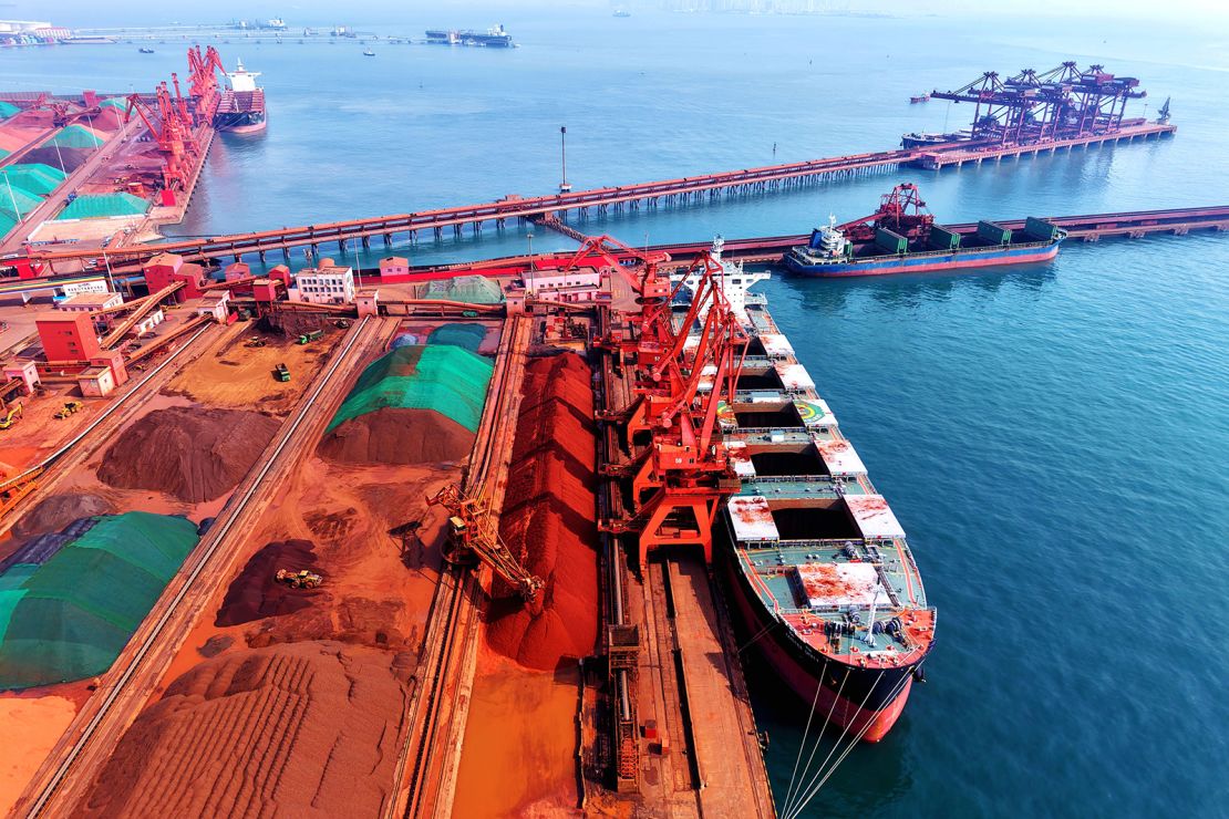 A cargo ship offloads imported iron ore at the Qingdao Port in Shandong province, China, on March 6, 2025.