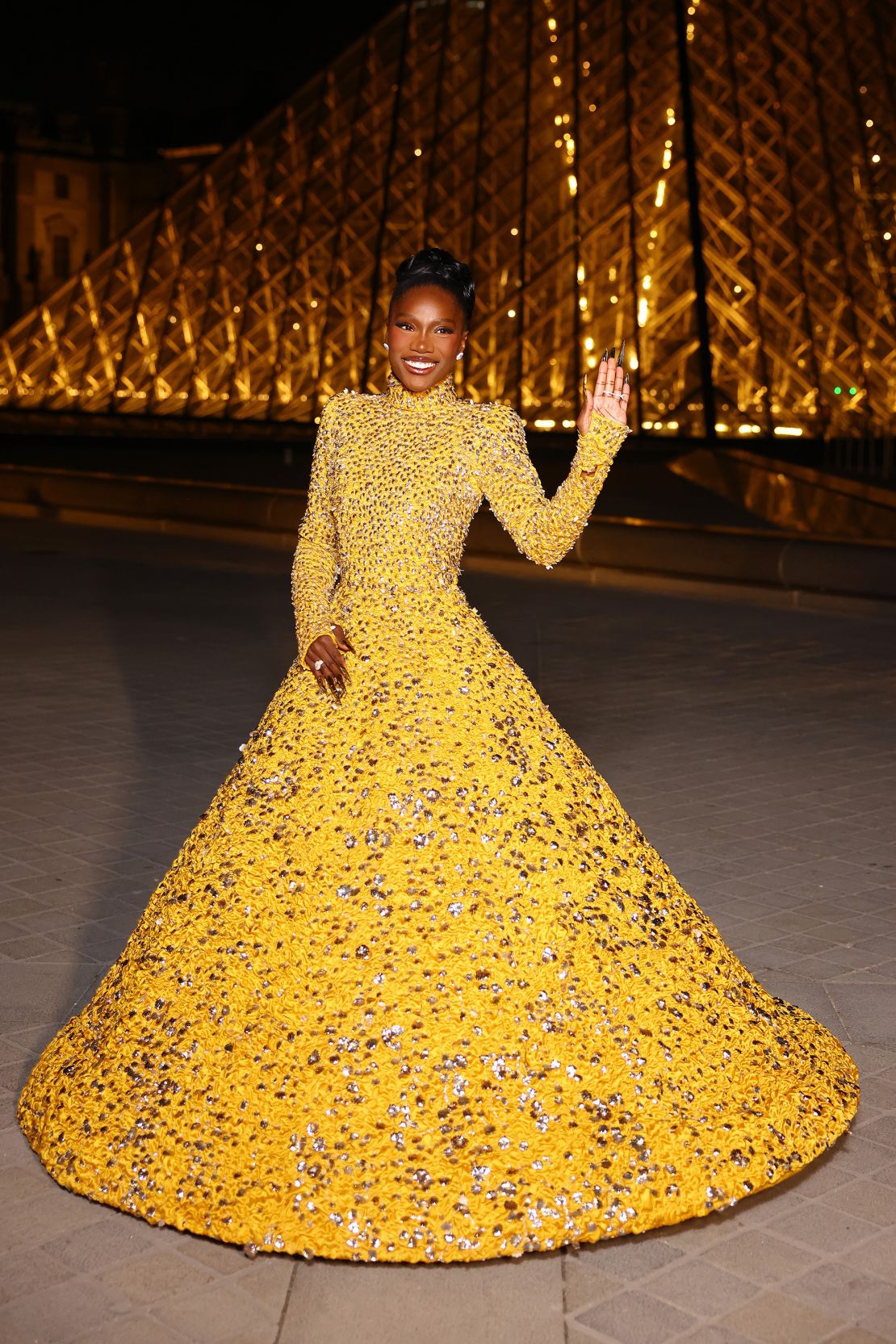 Doechii later changed into a dramatic yellow Valentino gown, which lit up the Louvre.