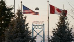 Canadian and American flags fly on the Canadian side of the Ambassador Bridge in Windsor, Ontario, on March 8.