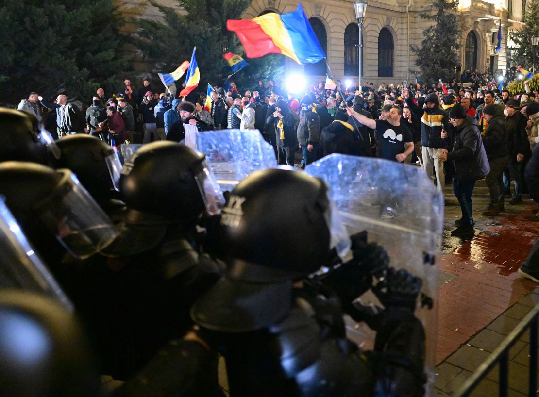 Supporters of Georgescu clash with police outside the BEC headquarters in Bucharest on Sunday.