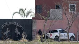 Police pickups are pictured at the entrance of the Izaguirre Ranch in the community La Estanzuela where the collective 'Guerreros Buscadores' located three human crematoriums while searching for their relatives in Teuchitlan, Jalisco state, Mexico on March 10, 2025. According to local authorities the Izaguirre Ranch was used by organized crime to train new . (Photo by ULISES RUIZ / AFP) (Photo by ULISES RUIZ/AFP via Getty Images)          