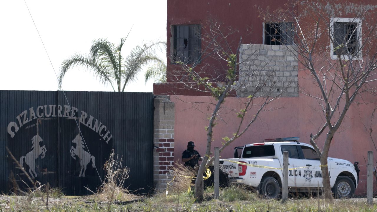 Police pickups are pictured at the entrance of the Izaguirre Ranch in the community La Estanzuela where the collective 'Guerreros Buscadores' located three human crematoriums while searching for their relatives in Teuchitlan, Jalisco state, Mexico on March 10, 2025. According to local authorities the Izaguirre Ranch was used by organized crime to train new . (Photo by ULISES RUIZ / AFP) (Photo by ULISES RUIZ/AFP via Getty Images)          