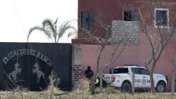 Police pickups are pictured at the entrance of the Izaguirre Ranch in the community La Estanzuela where the collective 'Guerreros Buscadores' located three human crematoriums while searching for their relatives in Teuchitlan, Jalisco state, Mexico on March 10, 2025. According to local authorities the Izaguirre Ranch was used by organized crime to train new . (Photo by ULISES RUIZ / AFP) (Photo by ULISES RUIZ/AFP via Getty Images)          