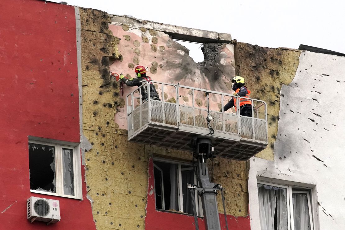 Specialists work on the facade of a damaged apartment building following a drone attack in Moscow, Russia, on Tuesday.