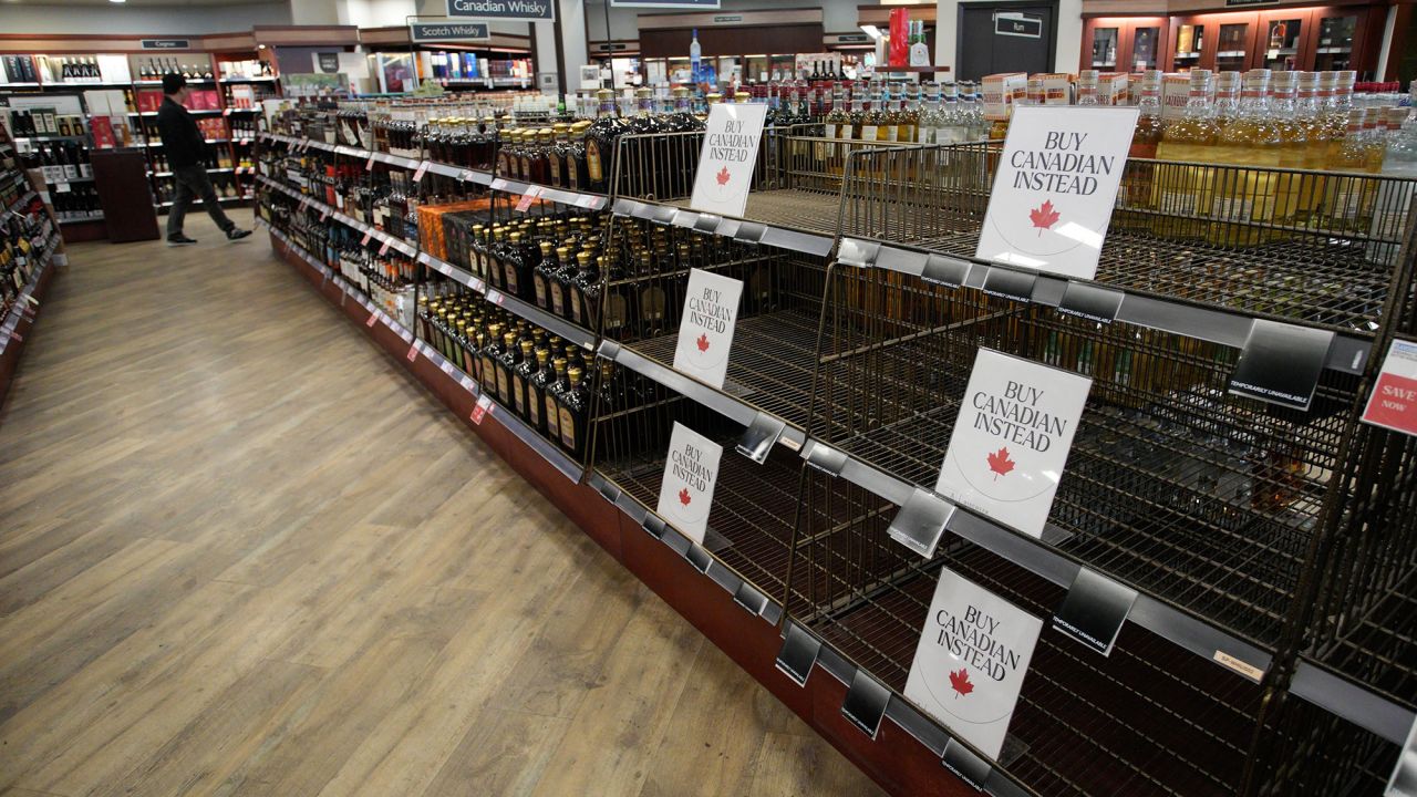 "Buy Canadian Instead" signs are placed on shelves at a liquor store in Vancouver.