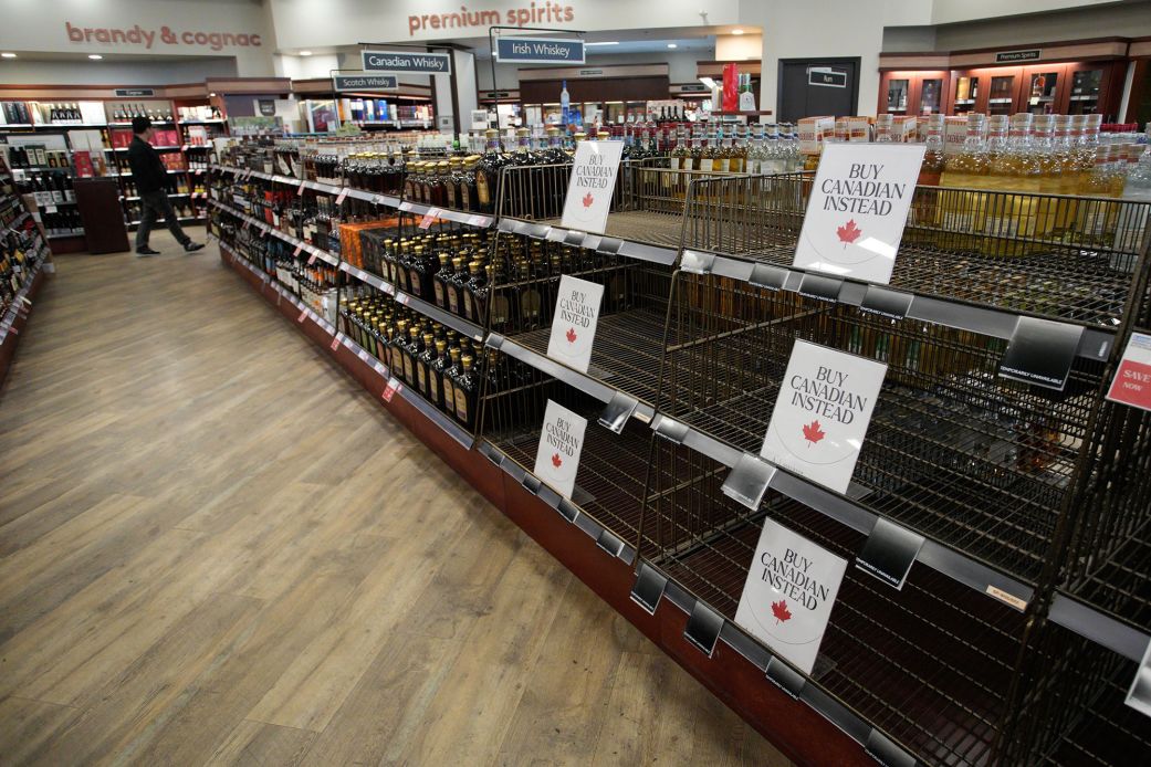 "Buy Canadian Instead" signs are placed on shelves at a liquor store in Vancouver in March.