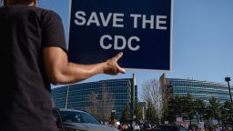 People protesting personnel cuts at the Centers for Disease Control (CDC) hold signs outside the organization's main headquarters on March 12, 2025 in Atlanta, Georgia. Some Centers for Disease Control and Prevention (CDC) employees have sent a letter to CDC leadership, they argue their dismissals were unfair and violated due process as they face a deadline that could officially end their employment status.