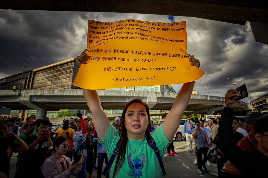 Supporters of former President Rodrigo Duterte gather outside the gate of Villamor Airbase, where Duterte was taken following his arrest on an International Criminal Court (ICC) warrant, on March 11, 2025 in Pasay, Metro Manila, Philippines.