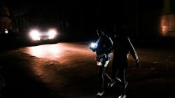 TOPSHOT - Cubans cross a street during a general blackout in Havana on March 14, 2025. Cuba suffered another general blackout on March 14, 2025, caused by a failure in its national electricity system, the Ministry of Energy and Mines reported. (Photo by YAMIL LAGE / AFP) (Photo by YAMIL LAGE/AFP via Getty Images)          