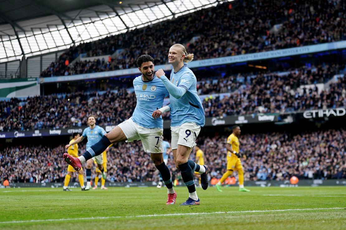 Haaland (right) celebrates with teammate Omar Marmoush.