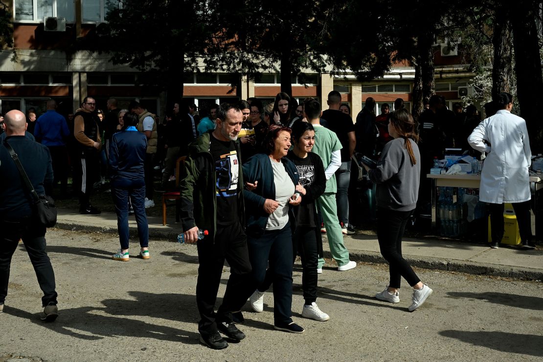 Friends and relatives of the victims gather in front of a hospital after the fire.