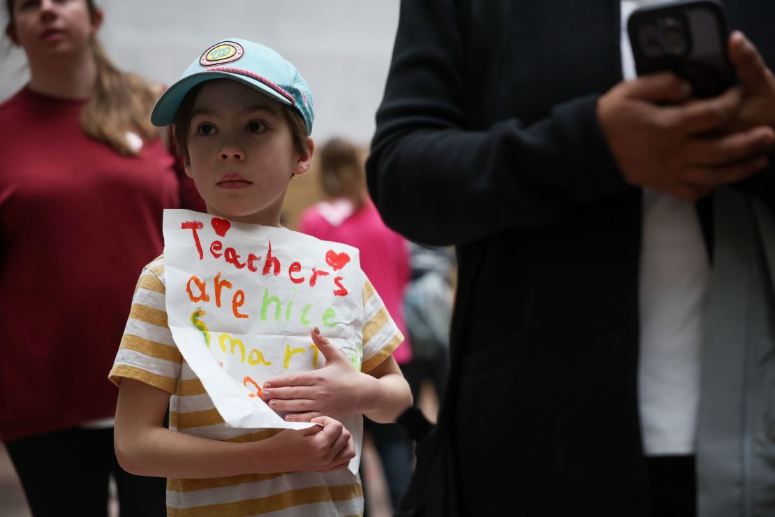 Jack Weigel, 7, holds a sign during a rally in the Hart Auditorium in support of the Department of Education and School at the US Capitol in Washington, DC, on March 13, 2025.