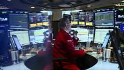 A trader works on the floor of the New York Stock Exchange (NYSE) at the opening bell, in the Financial District of New York City on March 17, 2025.