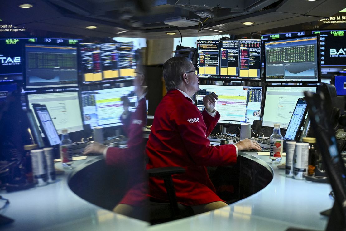 A trader works on the floor of the New York Stock Exchange (NYSE) at the opening bell, in the Financial District of New York City on March 17, 2025.