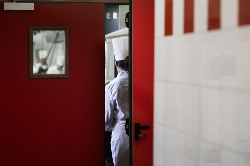 Students take part in a cooking class in a Paris kitchen as part of France's tourism careers week in March 2025.