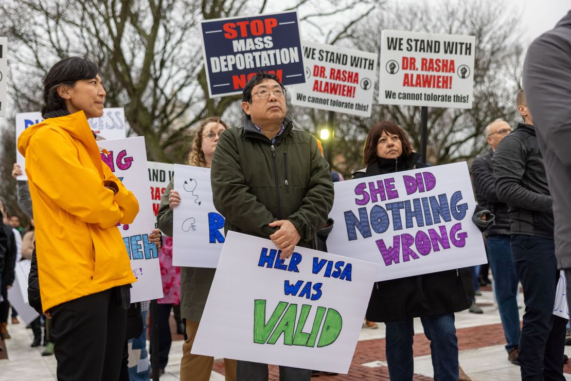 Demonstrators hold signs outside of the Rhode Island State House to protest the deportation of doctor and Brown University assistant professor <a href='https://www.cnn.com/2025/03/18/us/rasha-alawieh-brown-university-wwk/index.html'>Rasha Alawieh</a> on March 17. US Customs and Border Protection said Alawieh had attended the public funeral in Lebanon of <a href='https://www.cnn.com/2013/01/01/middleeast/hassan-nasrallah-fast-facts/index.html'>Hassan Nasrallah</a>, the long-time leader of Hezbollah, and a Department of Homeland Security spokesperson alleged she expressed support of Nasrallah to CBP officers.