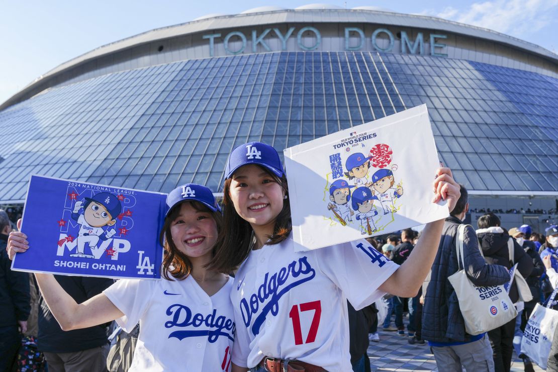 Fans pose for photographs ahead of the baseball game between Los Angeles Dodgers and Chicago Cubs in the MLB Tokyo Series outside of the Tokyo Dome in Tokyo on March 18, 2025. (Photo by Yuichi YAMAZAKI / AFP) / --IMAGE RESTRICTED TO EDITORIAL USE - STRICTLY NO COMMERCIAL USE-- (Photo by YUICHI YAMAZAKI/AFP via Getty Images)          
