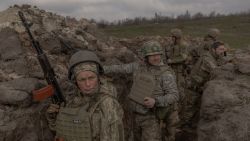 Combat medic and mother of three Natalia (L), 51, serving in the 24th Mechanized Brigade of the Ukrainian Military takes part with other military members in a field training exercise in an undisclosed location in the eastern region of Ukraine, on March 18, 2025, amid the Russian invasion of Ukraine. (Photo by Roman PILIPEY / AFP)