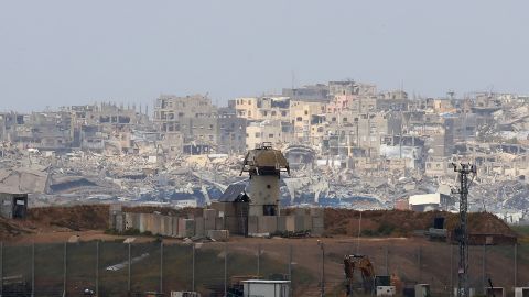 An Israeli military watch tower stands along Israel's southern border with the northern Gaza Strip backdropped by buildings destroyed during the Israel-Hamas war, on March 20, 2025. Israel bombarded Gaza and pressed its ground operations on March 20, after issuing what it called a "last warning" for Palestinians to return hostages and remove Hamas from power. (Photo by GIL COHEN-MAGEN / AFP) (Photo by GIL COHEN-MAGEN/AFP via Getty Images)