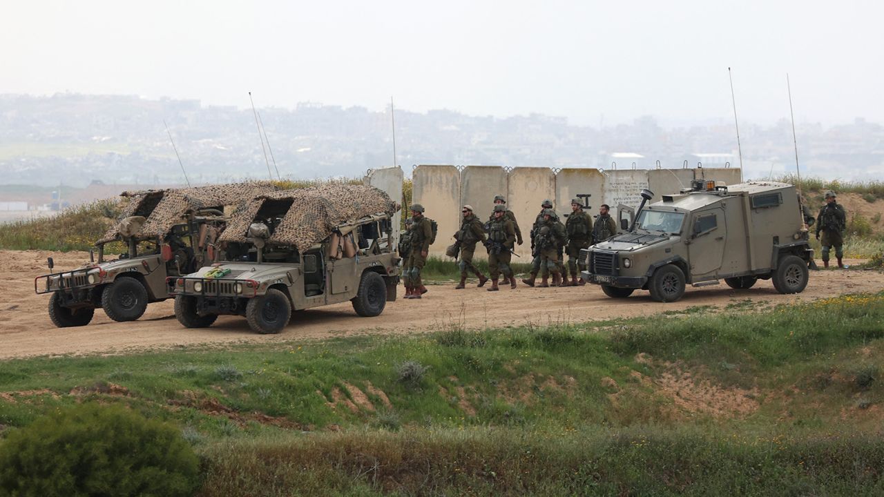 Israeli army soldiers walk in a position along Israel's southern border with the northern Gaza Strip on March 20, 2025. Israel bombarded Gaza and pressed its ground operations on March 20, after issuing what it called a "last warning" for Palestinians to return hostages and remove Hamas from power. (Photo by GIL COHEN-MAGEN / AFP) (Photo by GIL COHEN-MAGEN/AFP via Getty Images)          