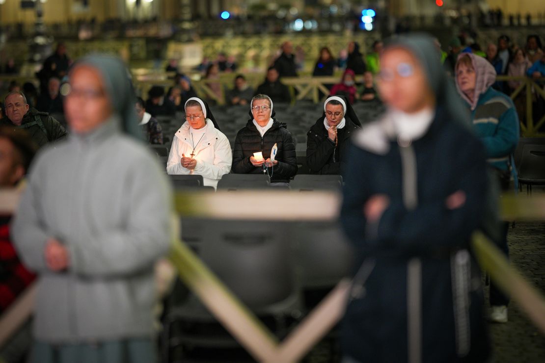 Nuns hold candles in St Peter's Square as they take part in the rosary prayer service for the health of Pope Francis on March 16.