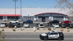Investigators look over the scene at a Tesla Collision Center after an individual used incendiary devices to set several vehicles on fire on March 18, 2025 in Las Vegas, Nevada.