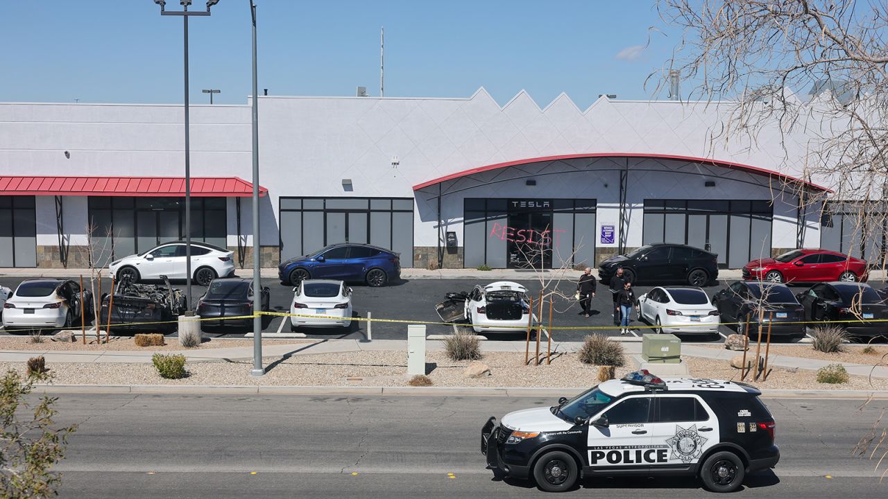 Investigators look over the scene at a Tesla Collision Center after an individual used incendiary devices to set several vehicles on fire on March 18, 2025 in Las Vegas, Nevada.