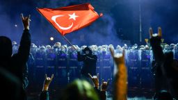 A protester waves Turkey's national flag before Turkish riot police, as protesters demonstrate outside Istanbul's city hall to support Istanbul mayor Ekrem Imamoglu, in Istanbul, on Saturday.