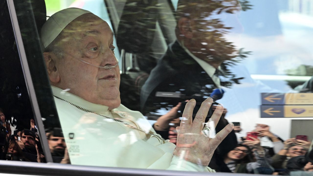 Pope Francis waves as he leaves by car the Gemelli hospital after a five weeks hospitalization for pneumonia, in Rome on March 23, 2025. Pope Francis is to leave hospital todayand return to his residence in the Vatican, where he is to spend "at least two months" recovering, one of his doctors announced during a press conference on March 22, 2025. (Photo by Tiziana FABI / AFP) (Photo by TIZIANA FABI/AFP via Getty Images)