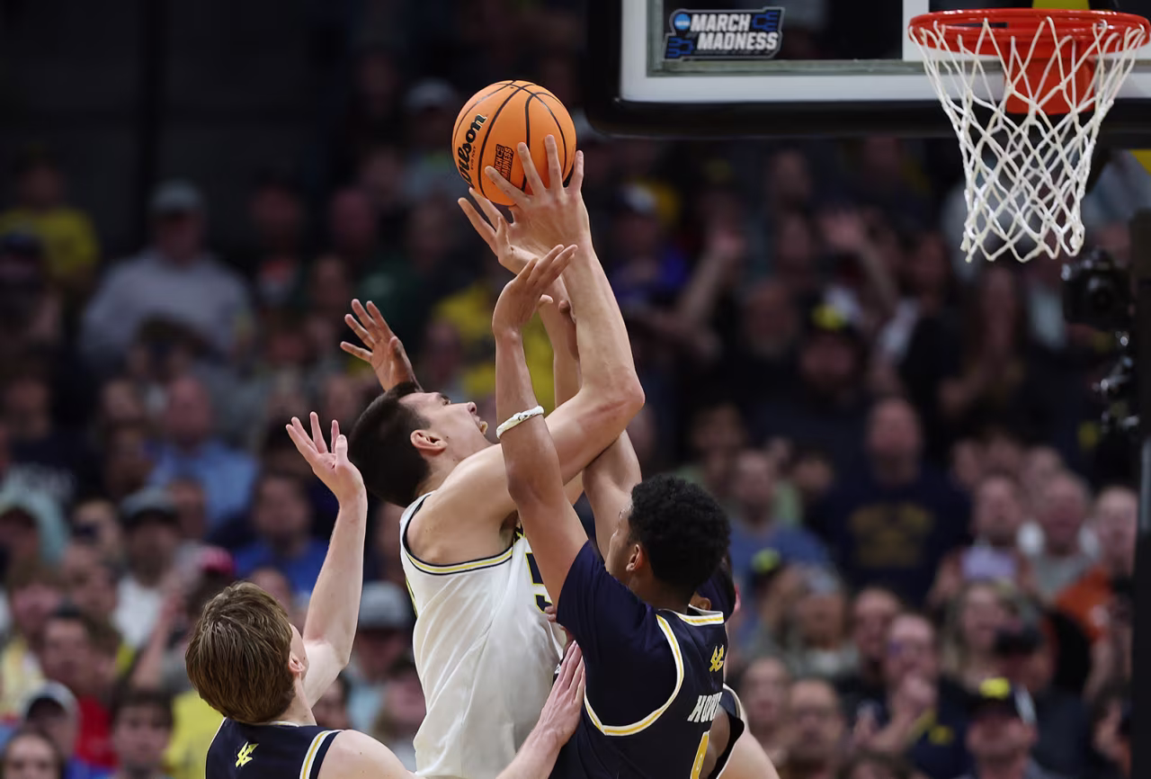 Vladislav Goldin #50 of the Michigan Wolverines shoots against Hayden Gray #3 and Chris Howell #8 of the UC San Diego Tritons during the NCAA Men's Basketball Tournament at Ball Arena in Denver, Colorado on Thursday.