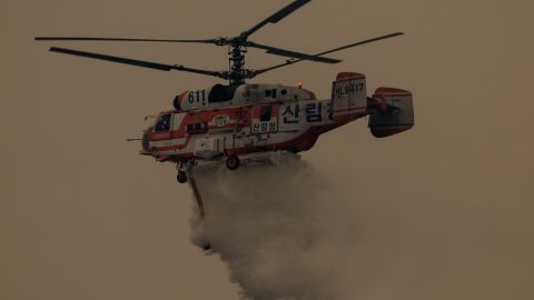 A helicopter takes part in an operation to extinguish a wildfire in Uiseong on March 24, 2025. South Korean authorities said on March 24 they would deploy dozens of helicopters and thousands of firefighters and soldiers as they struggle to control multiple wildfires in the southeast, which have been burning for days. (Photo by YASUYOSHI CHIBA / AFP) (Photo by YASUYOSHI CHIBA/AFP via Getty Images)          