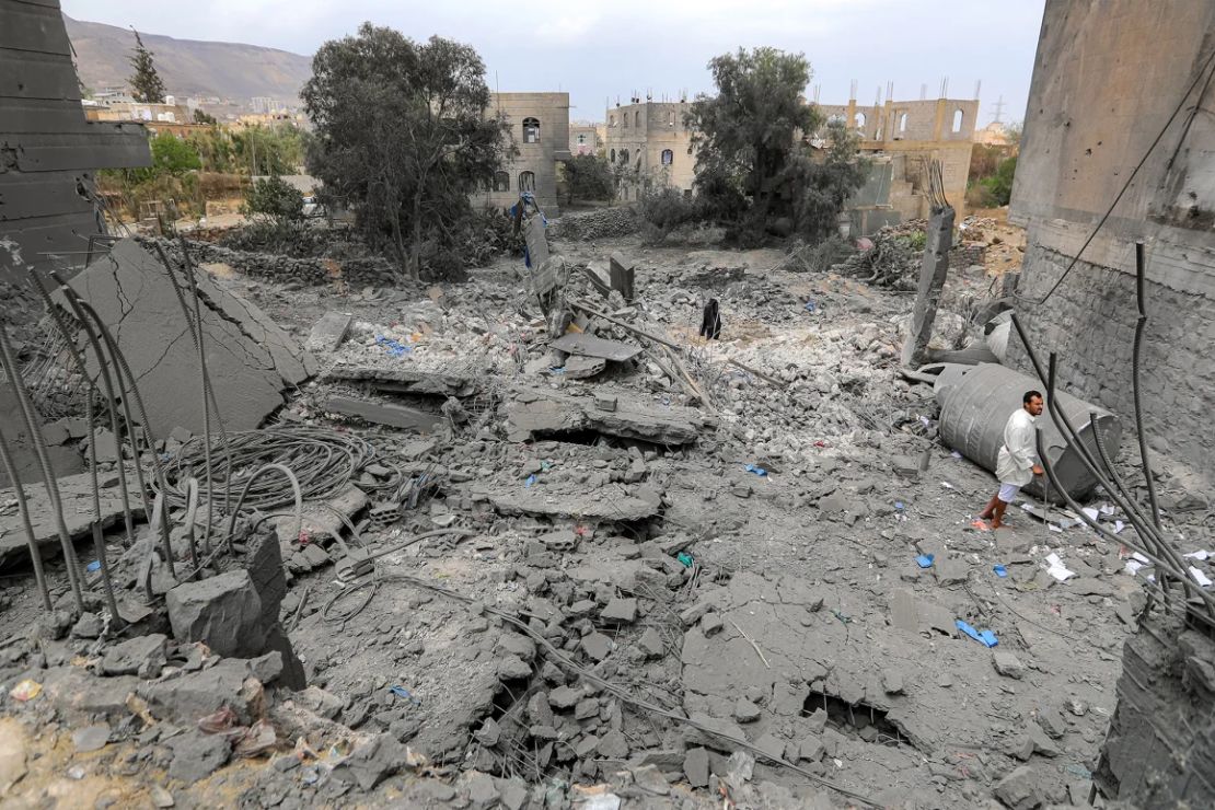 Un hombre se encuentra entre los escombros de un edificio colapsado en el sitio de un presunto ataque aéreo de EE.UU. en Sanaa, la capital controlada por los hutíes en Yemen, el 24 de marzo.