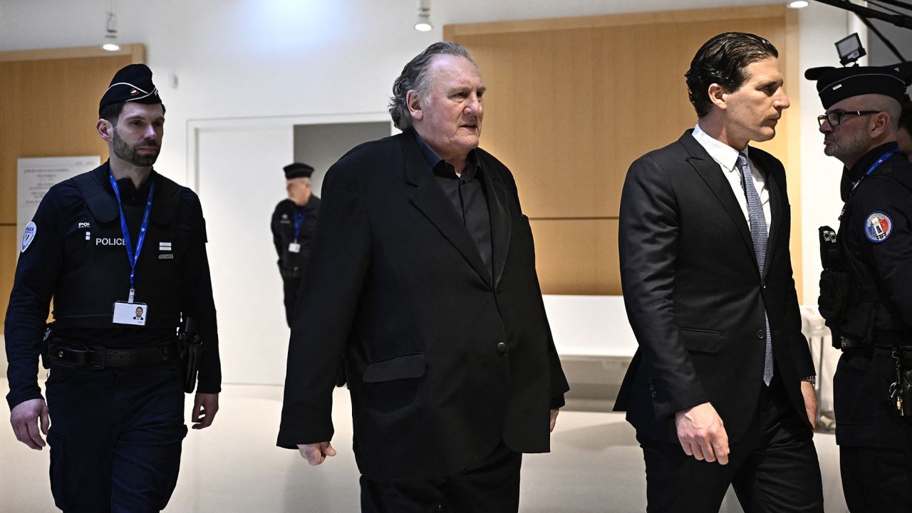 French actor Gerard Depardieu, center, walks with his lawyer Jeremie Assous, right, as he arrives for the opening of his trial at the Paris criminal court in the Tribunal de Paris courthouse, on Monday, March 24.