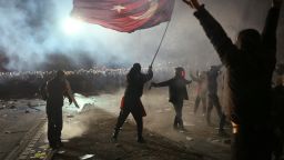 TOPSHOT - A protestor waves a Turkish flag in front of riot police during a rally in support of Istanbul's arrested mayor in Istanbul, on March 24, 2025. Turkish police have detained more than 1,100 people, including journalists, since the arrest of President Recep Tayyip Erdogan's main rival sparked the country's worst unrest in years, a minister said on March 24, 2025. (Photo by Angelos Tzortzinis / AFP) (Photo by ANGELOS TZORTZINIS/AFP via Getty Images)          