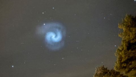 TOPSHOT - In this picture taken in the country-side near Dalby-Viggeby, south of Uppsala, Sweden just after 21:00 CET on March 24, 2025 shows a blue and white spiral in the night sky reportedly created by frozen fuel tumbling from a SpaceX rocket. A stunning blue and white spiral spotted in skies across Europe was created by frozen fuel tumbling from a SpaceX rocket, according to weather forecasters and scientists.
The UK's Met Office said on X it had received many reports of an "illuminated swirl" in the sky on Monday evening likely caused by a rocket that had earlier blasted off from Cape Canaveral in Florida. (Photo by Bertrand ILHE / AFP) / TO GO WITH AFP STORY  "Blue spiral in sky above France, UK likely from SpaceX rocket" (Photo by BERTRAND ILHE/AFP via Getty Images)          