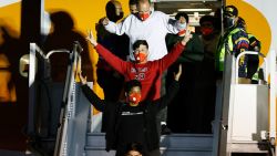 Venezuelan migrants deported from the United States gesture while walking down a plane upon arrival at Simon Bolivar International Airport in Maiquetia, Venezuela on March 28, 2025. (Photo by Pedro MATTEY / AFP) (Photo by PEDRO MATTEY/AFP via Getty Images)          
