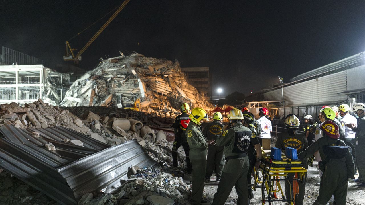Rescue teams arrive with a stretcher to evacuate an injured man at a construction site where a building collapsed in Bangkok on March 28, 2025, following an earthquake. A powerful earthquake killed more than 20 people across Myanmar and Thailand on March 28, toppling buildings and bridges and trapping over 80 workers in an under-construction skyscraper in Bangkok. (Photo by Chanakarn Laosarakham / AFP) (Photo by CHANAKARN LAOSARAKHAM/AFP via Getty Images)