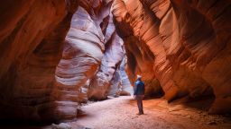 Lone hiker in Buckskin Gulch slot canyon - Utah, USA