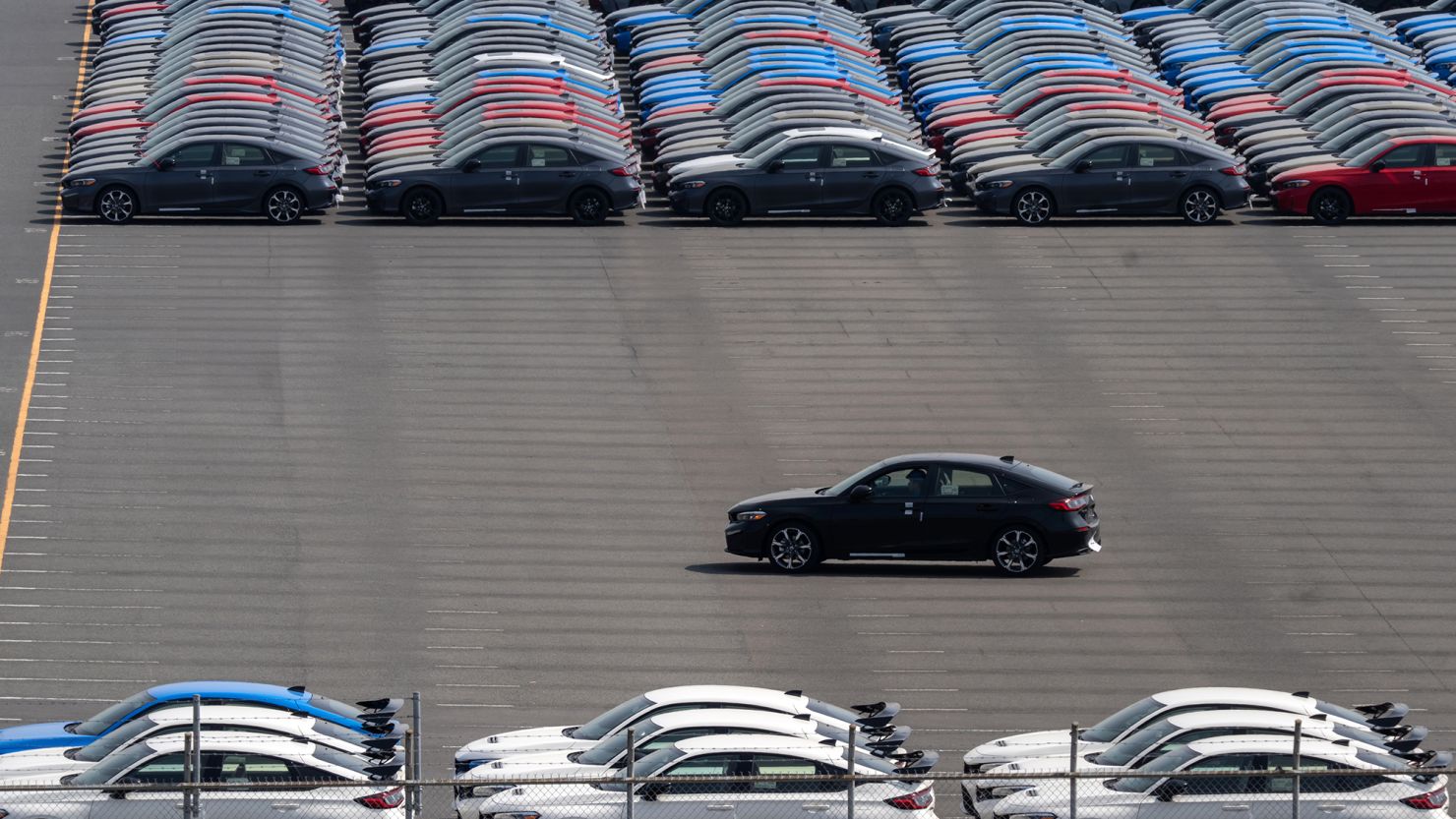 Vehicles awaiting shipment are parked at a port on March 27, 2025, in Yokohama, Japan.