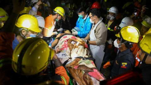 Doctors and medics teams treat a victim trapped under the rubble of the destroyed Sky Villa Condominium development in Mandalay on March 30, 2025. (Photo by Sai Aung MAIN / AFP) (Photo by SAI AUNG MAIN/AFP via Getty Images)          