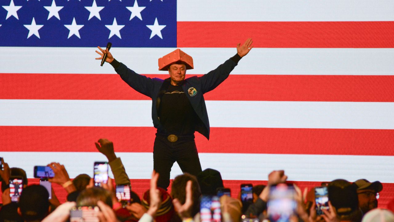 TOPSHOT - Elon Musk wears a Cheesehead hat as he speaks during a town hall in Green Bay, Wisconsin on March 30, 2025. An election to choose a new supreme court judge in the northern US state of Wisconsin wouldn't usually make much noise.
But when the world's richest man took an interest in the race, people began to notice, and protests on March 30 drew crowds.
Tech baron and political provocateur Elon Musk, a close ally of President Donald Trump, has poured money into the Tuesday election, hoping to secure a conservative win. (Photo by Robin LEGRAND / AFP) (Photo by ROBIN LEGRAND/AFP via Getty Images)          
