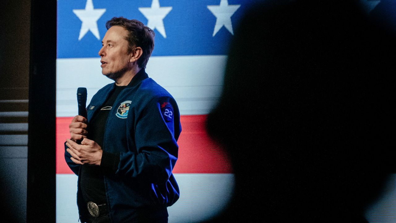 Elon Musk, chief executive officer of Tesla Inc., speaks during an America PAC town hall ahead of the Wisconsin Supreme Court election at the KI Convention Center in Green Bay, Wisconsin, US, on Sunday, March 30, 2025. Musk's plan to hand out $1 million checks to two residents for participating in Wisconsin's Supreme Court election is barred by state law, a new complaint said Friday. Photographer: Jamie Kelter Davis/Bloomberg via Getty Images