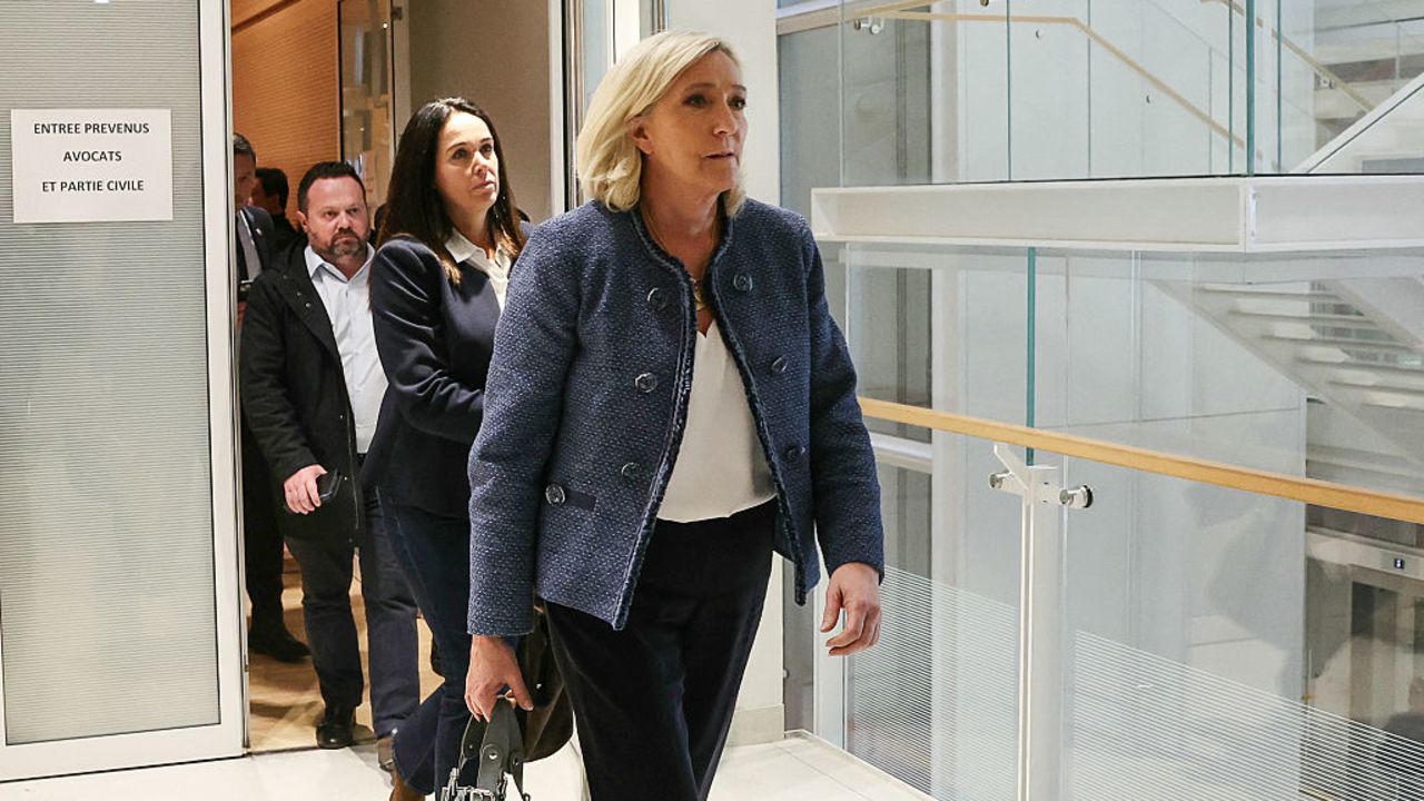 President of the parliamentary group of the French far-right Rassemblement National (RN) party, Marine Le Pen (R), walks followed by co-defendant French member of European Parliament Catherine Griset (L) as they exit a courtroom while leaving the Tribunal de Paris courthouse during the reading of sentencing in their trial verdict on suspicion of embezzlement of European public funds, in Paris, on March 31, 2025. A French court on March 31, 2025 convicted far-right leader Marine Le Pen on charges of embezzlement of public funds over a fake jobs scam at the EU parliament, and has banned her from running for office after conviction. (Photo by ALAIN JOCARD / AFP) (Photo by ALAIN JOCARD/AFP via Getty Images)          