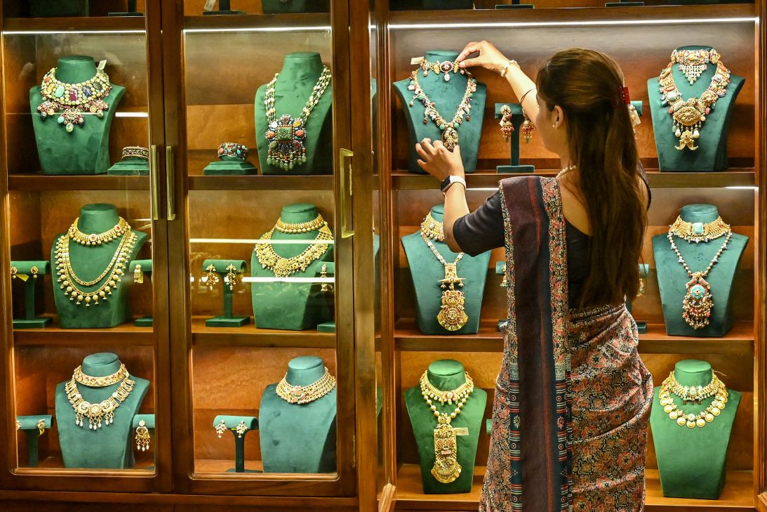 An employee arranges gold jewellery kept for display at a store in Amritsar on April 2, 2025.