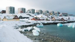 Painted houses and residential apartment blocks overlook the fjord in Nuuk, Greenland, on April 3.