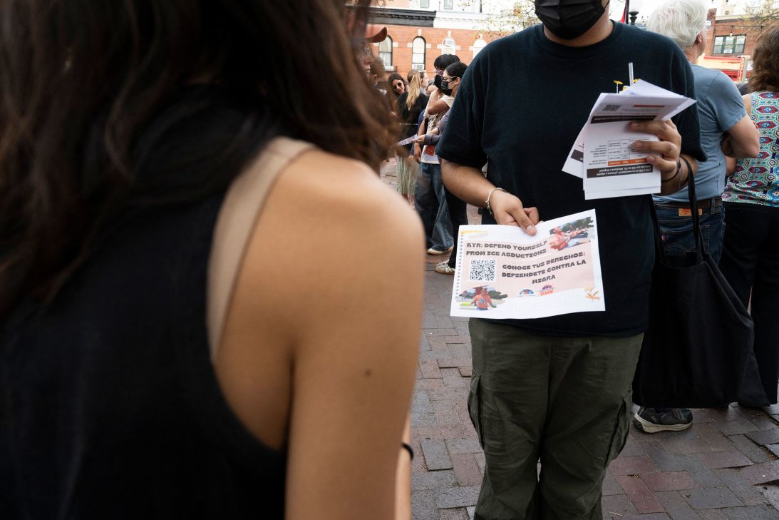 A man hands out 'know your rights' fliers at a DC protest on April 4.