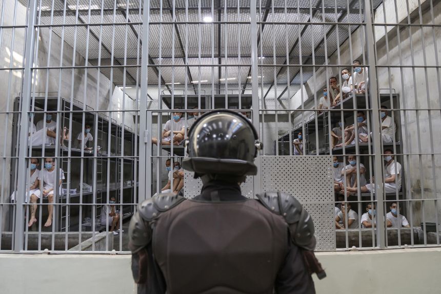 A prison officer guards a cell at maximum security penitentiary CECOT (Center for the Compulsory Housing of Terrorism) on April 4, 2025, in Tecoluca, San Vicente, El Salvador.