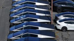Tesla Cybertrucks sit parked in a lot outside a Tesla showroom. Tesla has reported the two largest drops in sales in its history in the last two quarters.