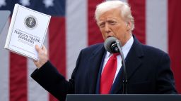 WASHINGTON, DC - APRIL 02: U.S. President Donald Trump holds up a copy of a 2025 National Trade Estimate Report as he speaks during a “Make America Wealthy Again” trade announcement event in the Rose Garden at the White House on April 2, 2025 in Washington, DC. Touting the event as “Liberation Day”, Trump is expected to announce additional tariffs targeting goods imported to the U.S. (Photo by Chip Somodevilla/Getty Images)