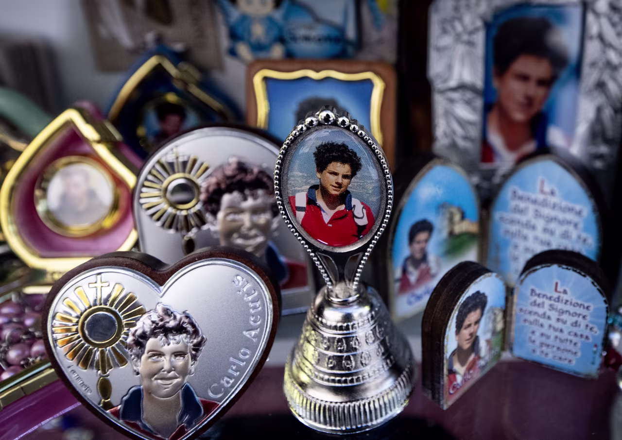 Pictures of Blessed Carlo Acutis, an adolescent who spent his life spreading his faith online, earning the moniker "God's Influencer", are printed on souvenirs in a shop of Assisi where Acutis is on display, on April 3.